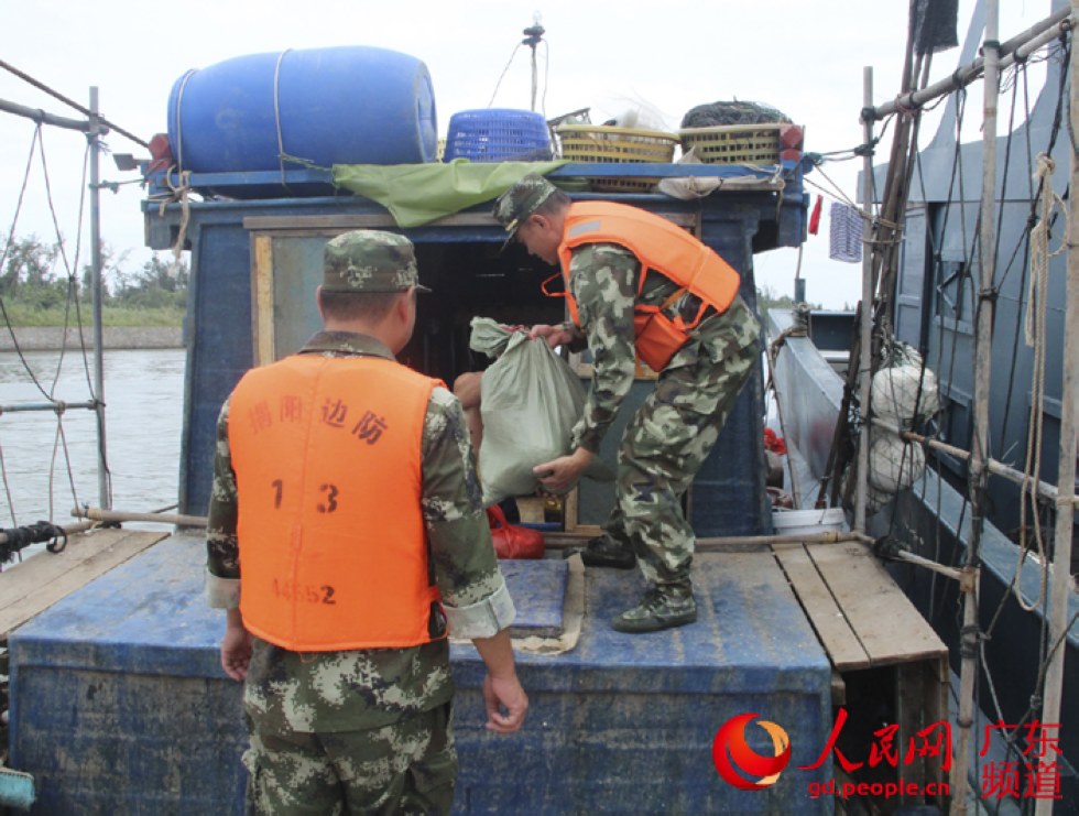 广东边防官兵帮助渔民转移物资。