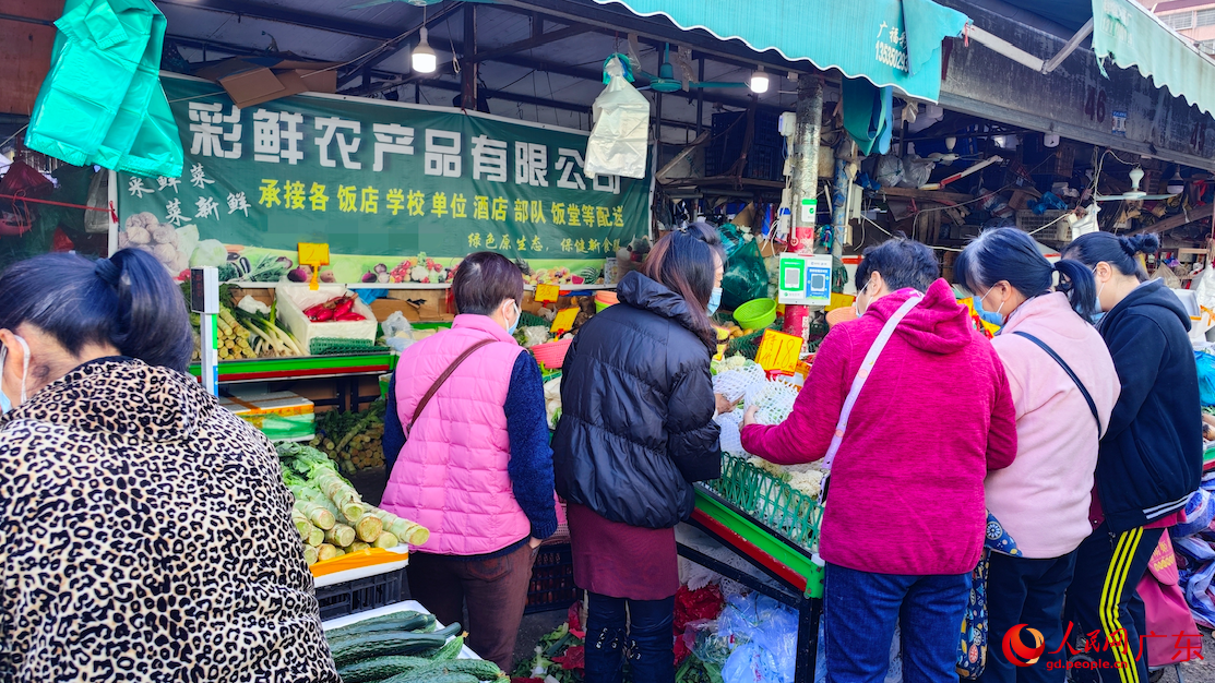 12月7日，在廣州市棠德農副產品綜合市場，市民們圍在攤前，購買果蔬。朴馨語 攝
