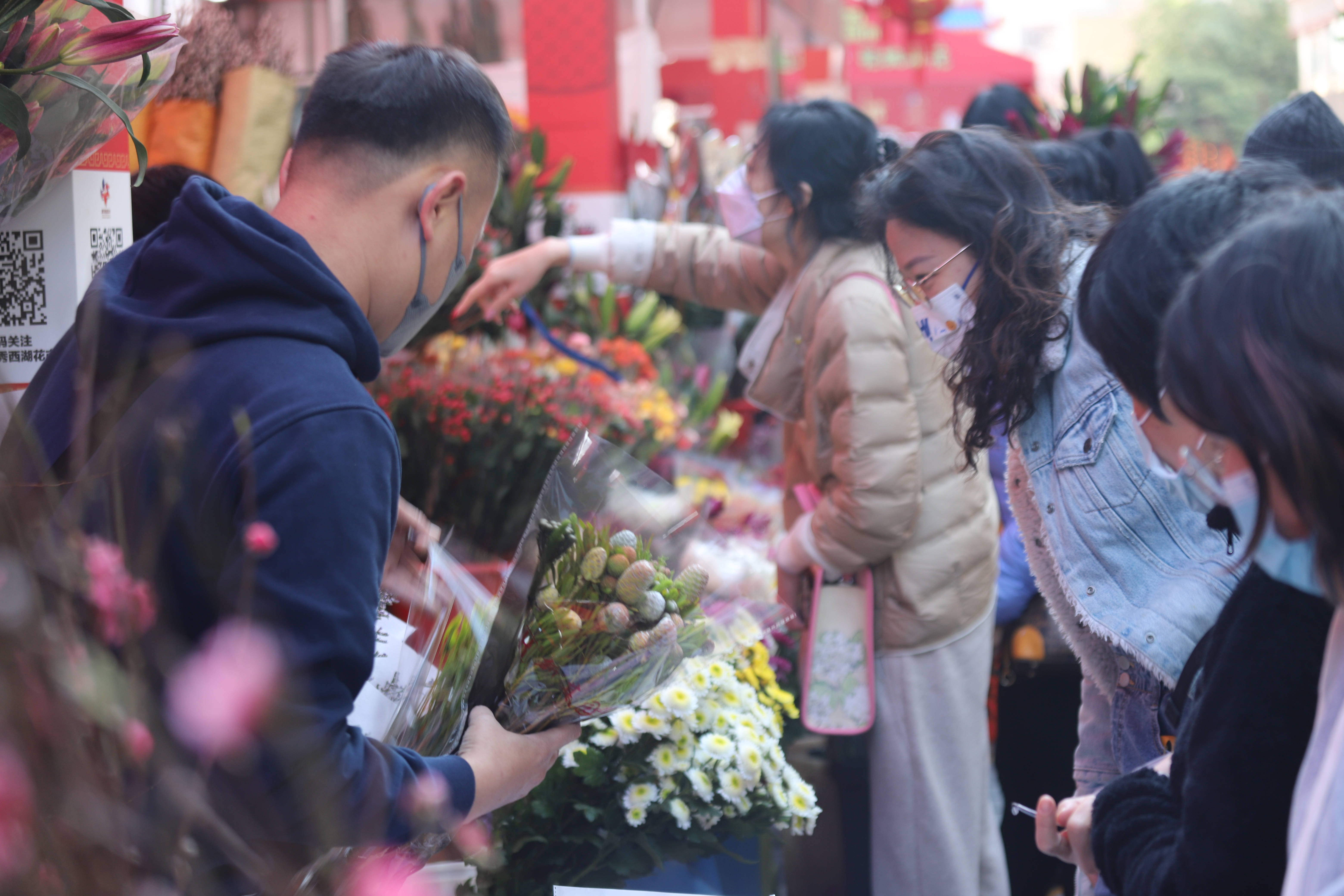 1月19日，广州市越秀西湖花市内热闹非凡、百花盛放，市民正在挑选年货和鲜花。胡嘉韵 摄